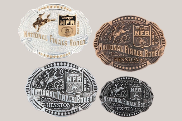 Collection of Wrangler NFR Hesston championship rodeo buckles in gold, silver, and bronze