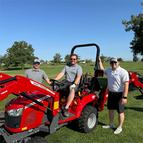 golf fore good people in front of tractor
