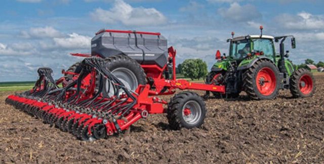 Fendt tractor towing a HORSCH Avatar disc seeder across a wide, freshly cultivated field under a bright sky with scattered clouds.