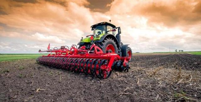 Fendt tractor pulling a HORSCH planter across a freshly tilled field under a dramatic orange sky, showcasing advanced planting equipment in action.