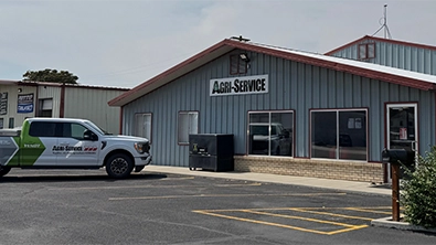 Front of Agri-Service Ontario dealership with company truck parked outside.
