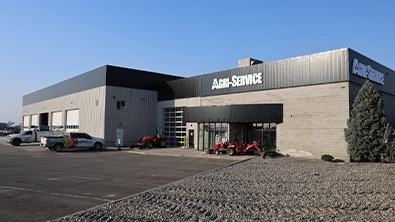 Agri-Service Pasco dealership with multiple service bays and equipment on display.