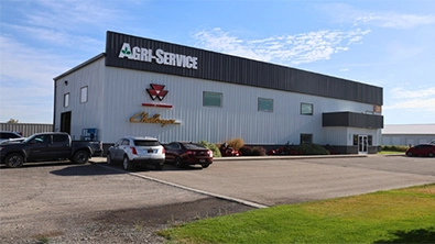 Agri-Service Sugar City dealership building with signage and customer parking area.