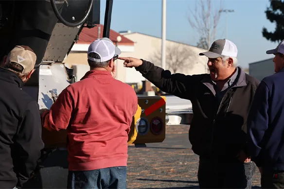 Agri-Service application operators reviewing details on ag equipment.